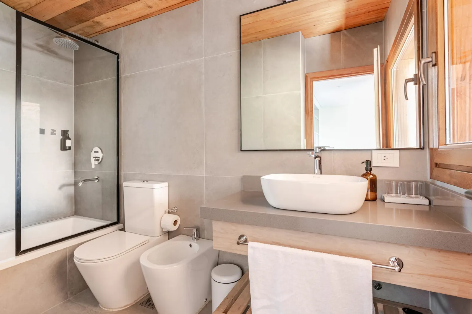 Contemporary bathroom finished in stone and natural wood