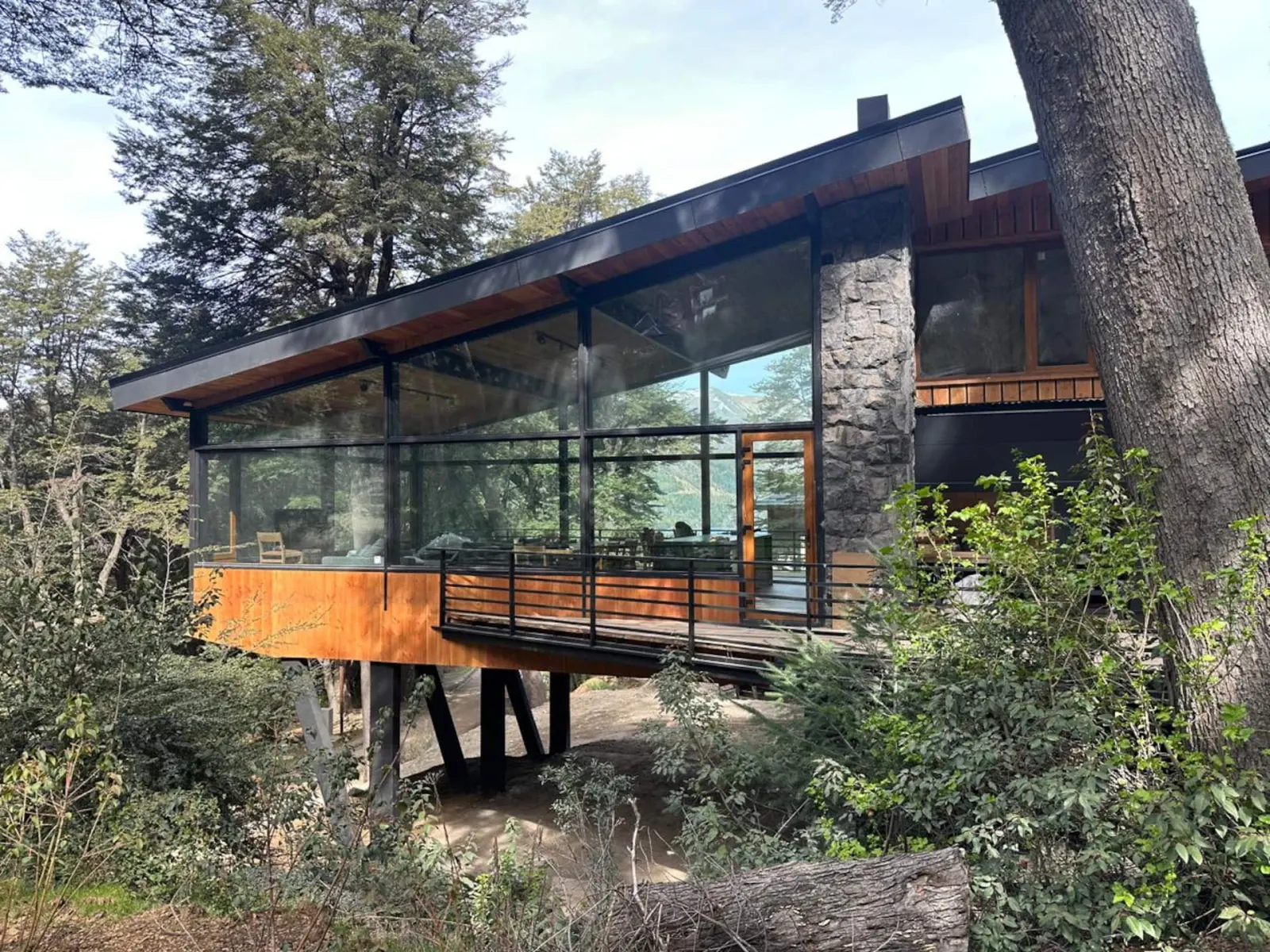 La Invernada's stone and timber exterior among native trees