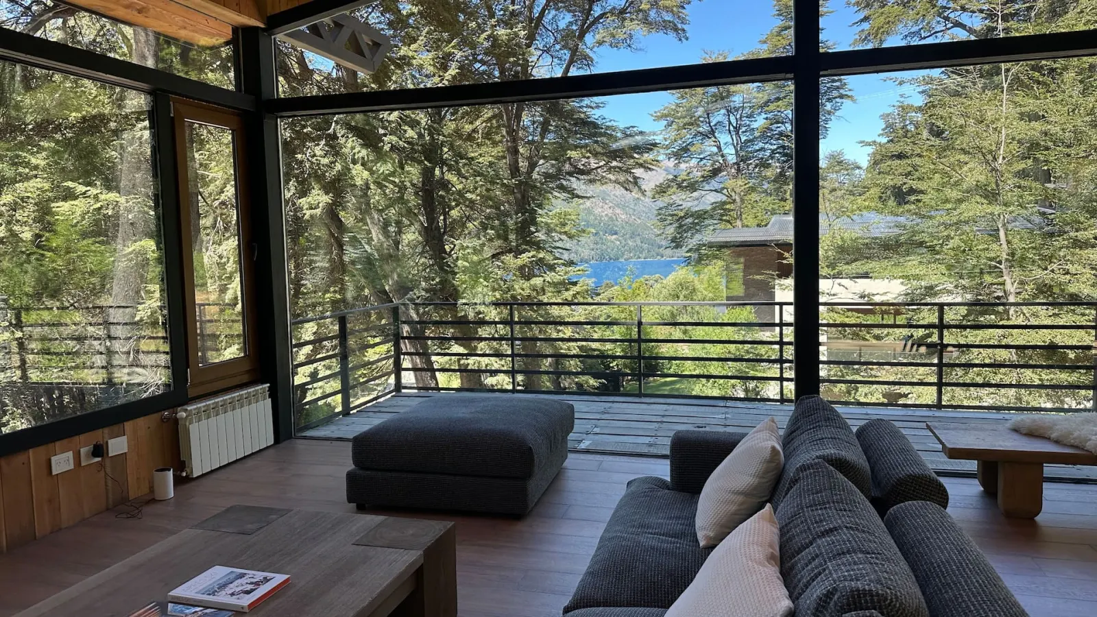 Lounge framed by the forest with Lake Gutiérrez beyond